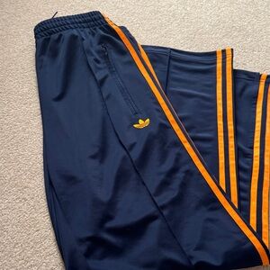 Adidas Women's Dark Blue Joggers with Bright Orange Accents
